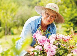 Photo of a woman working in her garden. Link to Life Stage Gift Planner Over Age 70 Situations.