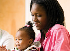 Photo of a woman smiling at her daughter. Link to Life Stage Gift Planner Under Age 60 Situations.